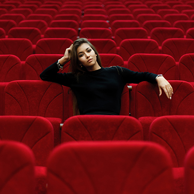 Woman sitting in empty theatre