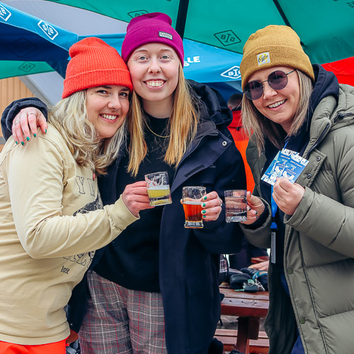 Three people at Brewski on Cypress Mountain holding small beer glasses